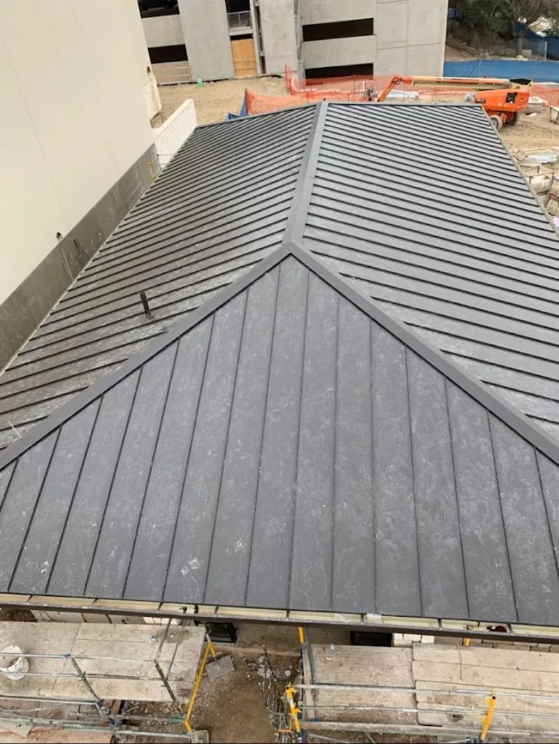 Commercial metal roof construction with crane equipment in Smyrna